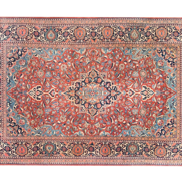 Woven around 1900, this early 20th-century Persian Kashan rug is a stunning example of traditional craftsmanship and...