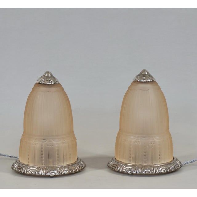 Muller freres Luneville A pair of French art deco lamps in nickel plated bronze, around 1925-1930, holding beautiful...