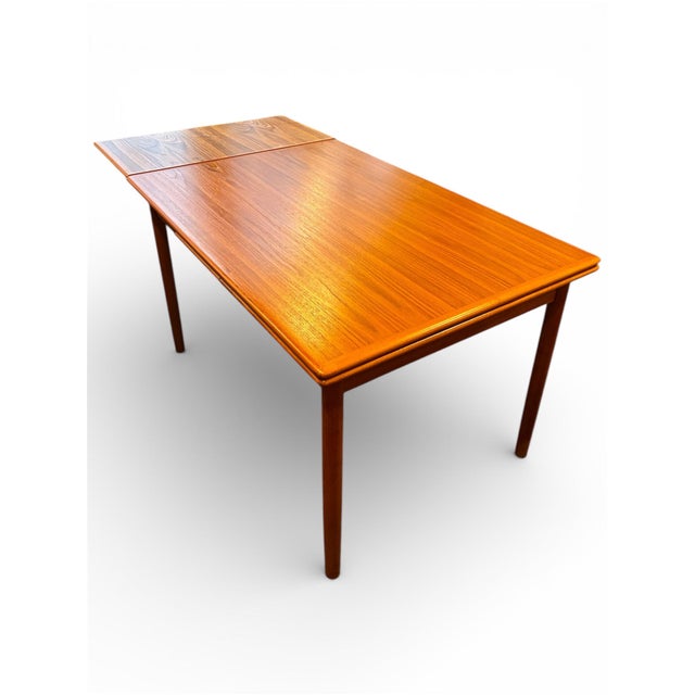 Danish-made extension dining table built from a mix of solid and veneered Burmese teak with exceptional old-growth, highly...