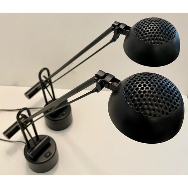 Pair of black Postmodern table lamps. They are adjustable in height and shades move up and down too. Switches are located...