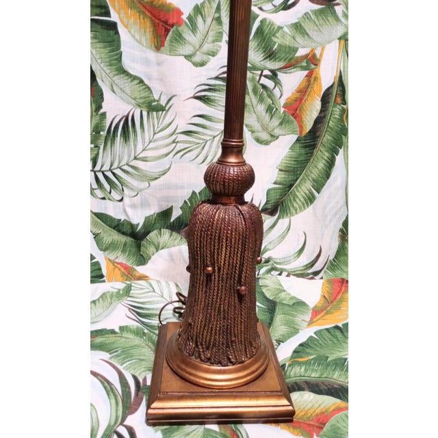 A gorgeous extra tall Hollywood Regency large tassel table lamp. The lamp features an Vintage gold color with beautiful...