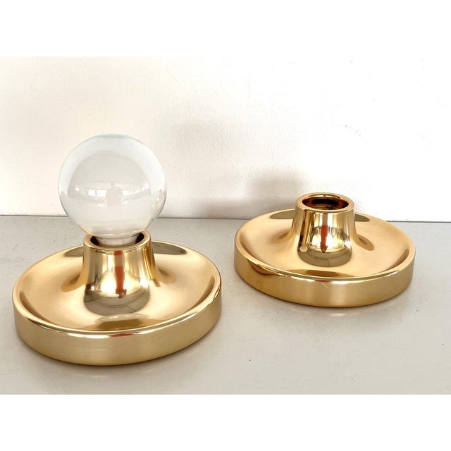 A Pair of golden, very shiny painted flush mount lights. Manufactured by Tronconi, Italy. Can be used also to be mount at...
