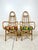 Vintage pair of rattan tall back arm chairs. High arched back with pencil reed accents. Curved arms. Removable cushions....