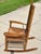 This vintage oak, rocking chair, has a comfortable rush-woven seat and backrest, with an extra wide and deep seat, too! It...