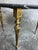 Elegant vintage coffee table with a round black marble top and ornate brass-coloured legs. The dark marble has beautiful...