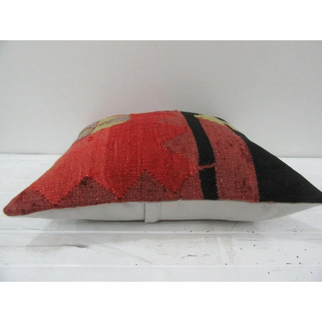 This is a pillow cover made from a vintage kilim rug. The piece was properly washed and ready to use. Pillow inserts not...