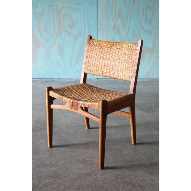 A danish modern classic , the CH31 chair designed by Hans J. Wegner for Carl Hansen and Søn. Cane and Oak, featuring a...
