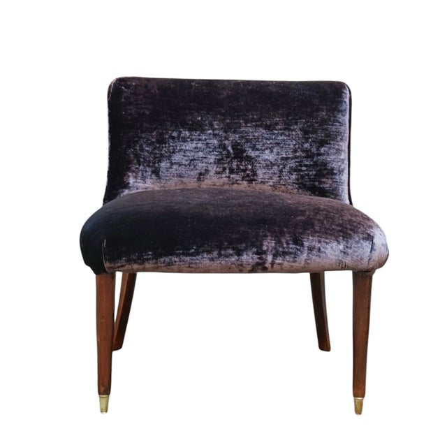 A small armchair in purple velvet, it stands out for its soft and inviting silhouette, made even more distinctive by the...