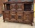 An impressive early 20th-century hand-carved oak sideboard from Brittany, France, featuring richly carved figural and...