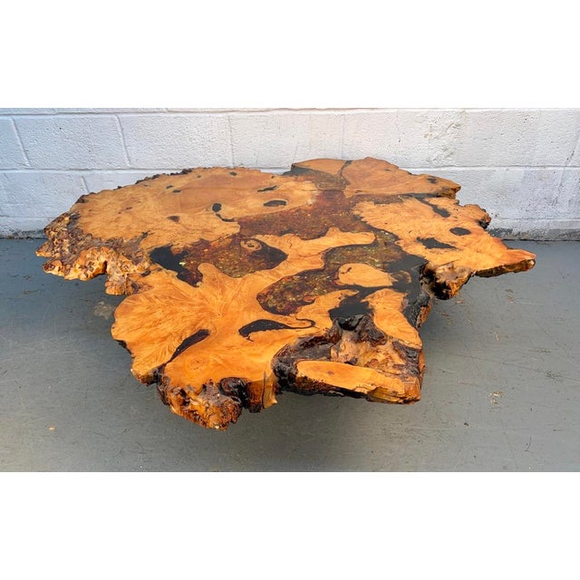 A striking statement coffee table crafted from solid wood and finished with a high-gloss epoxy and embedded glitter for...