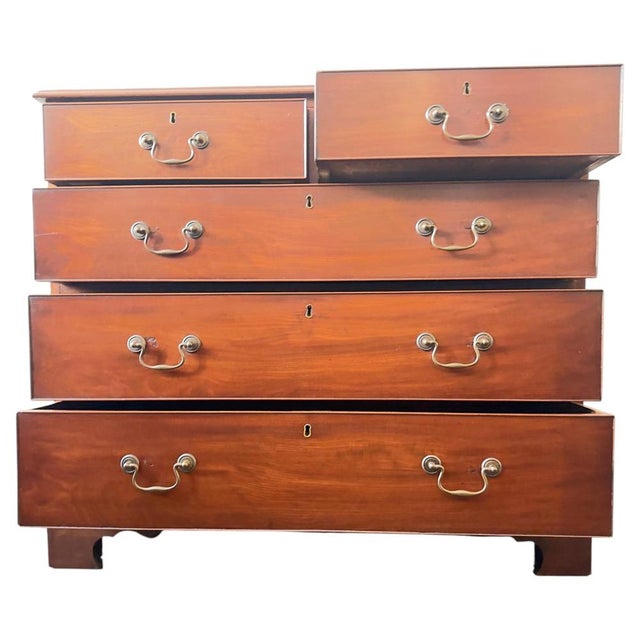 Antique timeless British elegance into your home with this exquisite George III chest of drawers, dating from the 19th...