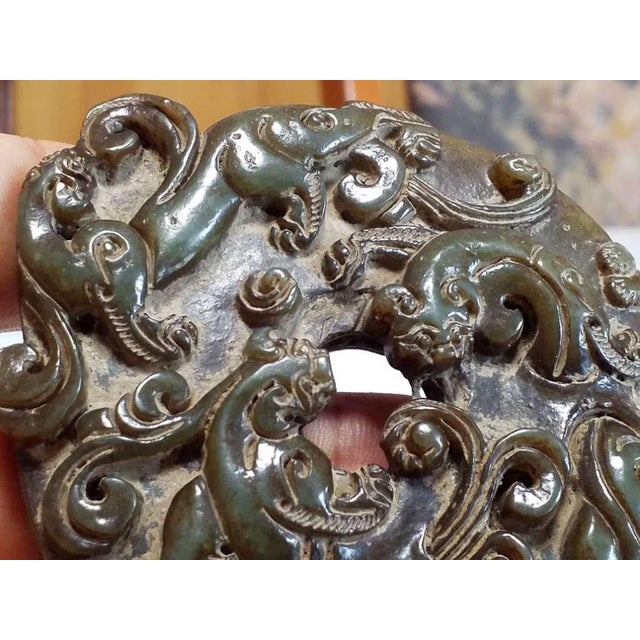 An elegant antique Chinese jade bi disc, carved in the traditional circular form with a central aperture symbolizing...