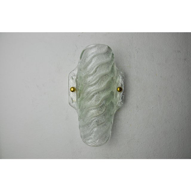 Superb wall lamp in frosted glass designated and produced in Italy in the 70s. White frosted murano glass supported by a...