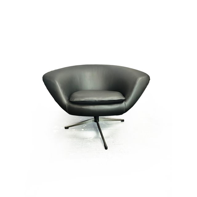 A striking example of scandinavian mid-century design, this pod swivel is without makers mark, however displays the work...