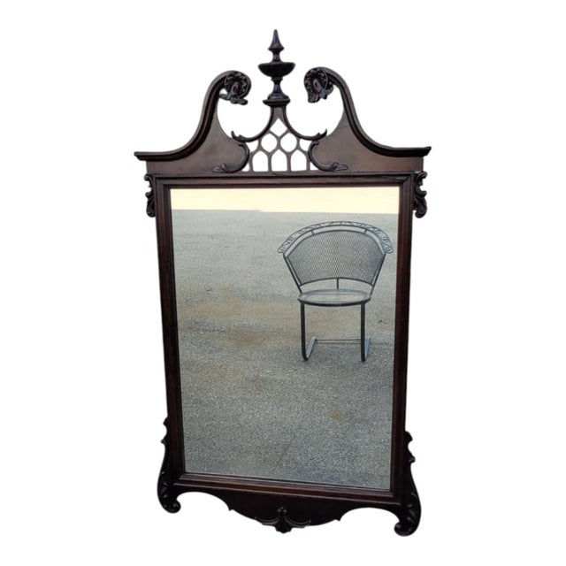 Elegant antique Chippendale-style wall mirror dating to the 1920s, crafted from solid mahogany and featuring a beautifully...
