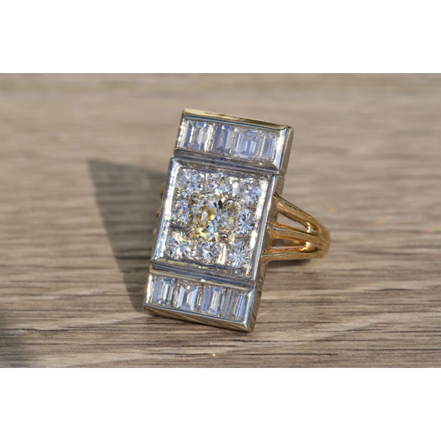 The Analia Ladies Antique Two Tone Diamond Ring in 14K. This unique ring centers on a 0.56 carat round diamond surrounded...