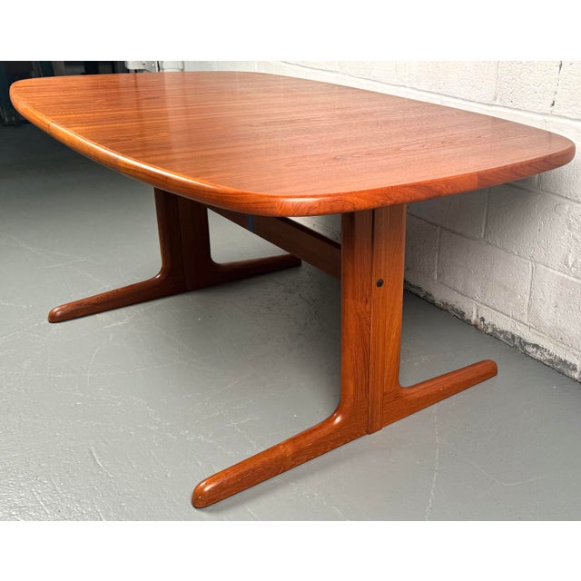 Elevate your dining experience with this exquisite vintage teak dining table, featuring two convenient leaves that adapt...