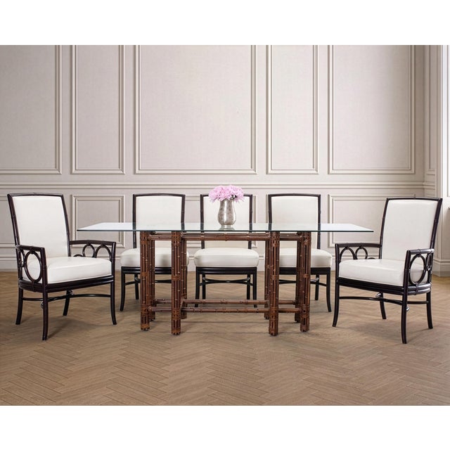A stylish set of eight dining leather and rattan dining chairs made by McGuire, San Francisco, CA. The distinctive set is...