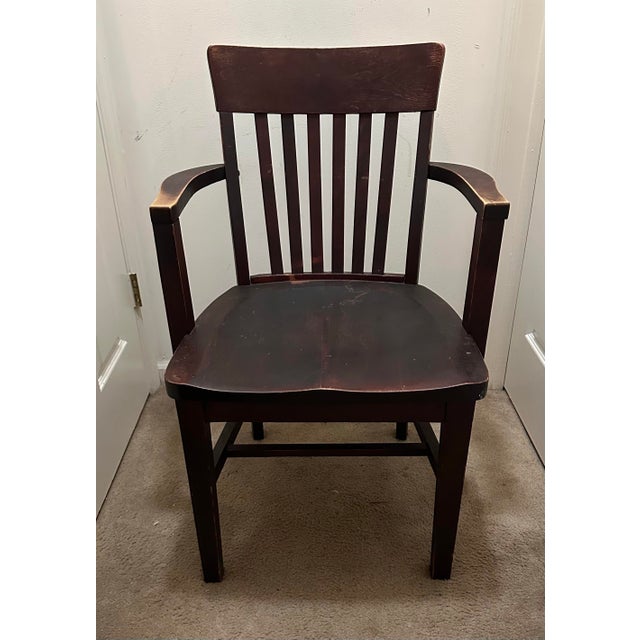 An authentic, early 20th-century antique banker's or courthouse armchair manufactured by the legendary Heywood-Wakefield...