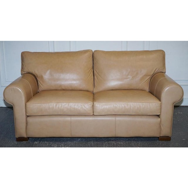 A fine latte brown leather two seater sofa, made by Multiyork England, beautifully designed with classic proportions and a...