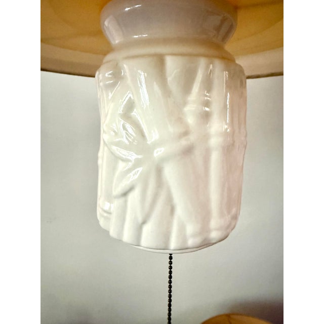 Here is a fabulous pair of vintage swag pendant lights featuring sculptural faux bamboo porcelain bodies, linen drum...