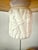 Here is a fabulous pair of vintage swag pendant lights featuring sculptural faux bamboo porcelain bodies, linen drum...