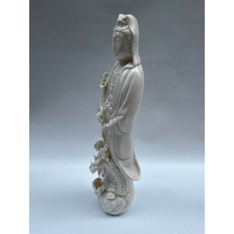 A single Chinese porcelain "blanc de chine" figure of a guan yin on a round base.