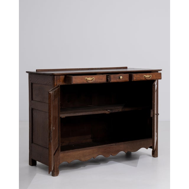 A Louis XV style buffet featuring curved lines and shaped panels. The structure combines decorative movement with...