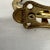 Brass single arm robe /coat / hat hook with white knob finials. Measures 1.5” w x 4.5” d x 6” h. Great for entryways or...