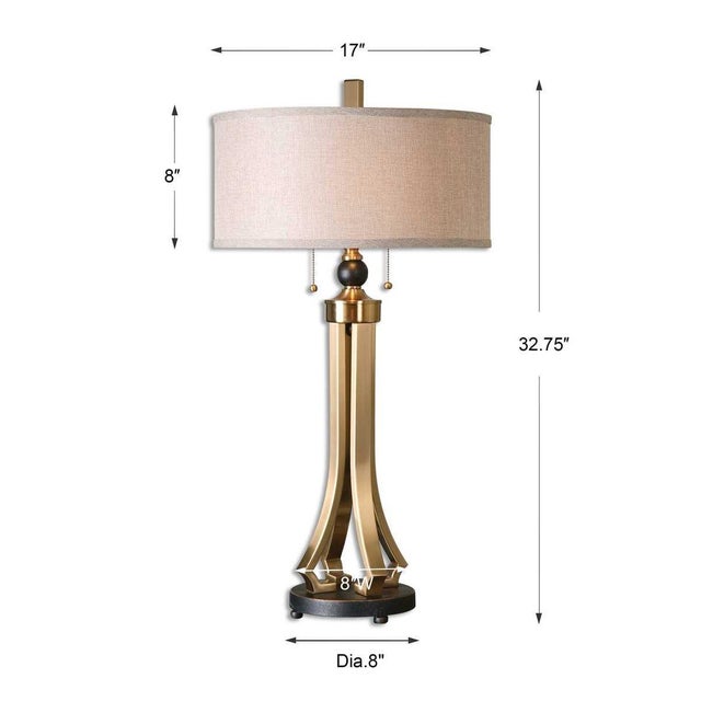 Astrength in desin and mateials this brushed brass muted finished metal accented with black/bronze orb at the top and...