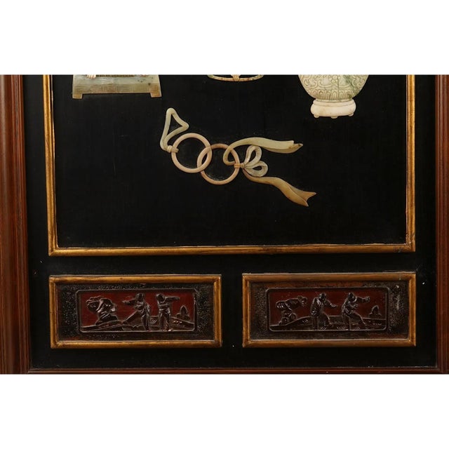 A pair of vintage Chinese black lacquer wall panels decorated with high-relief jade and hardstone inlays in mirror-image...