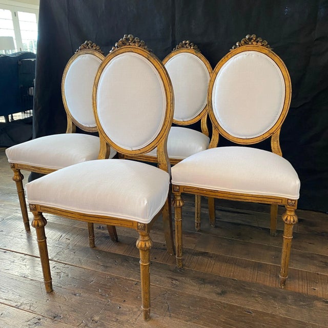 Stunning and romantic set of four antique French Neoclassical Louis XV chairs in original gold gilt paint, newly...