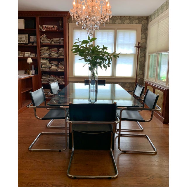 Set of six MG5 dining chairs, Italy, circa 1980s. Featuring polished tubular chrome frames with integrated armrests and...