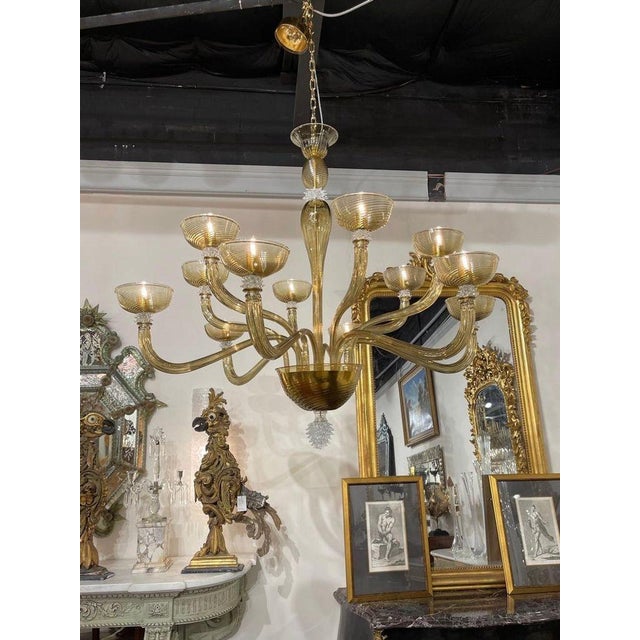 Spectacular modern gold Murano glass chandelier with 12 arms. This sparkling beauty makes a very impressive impact. A true...