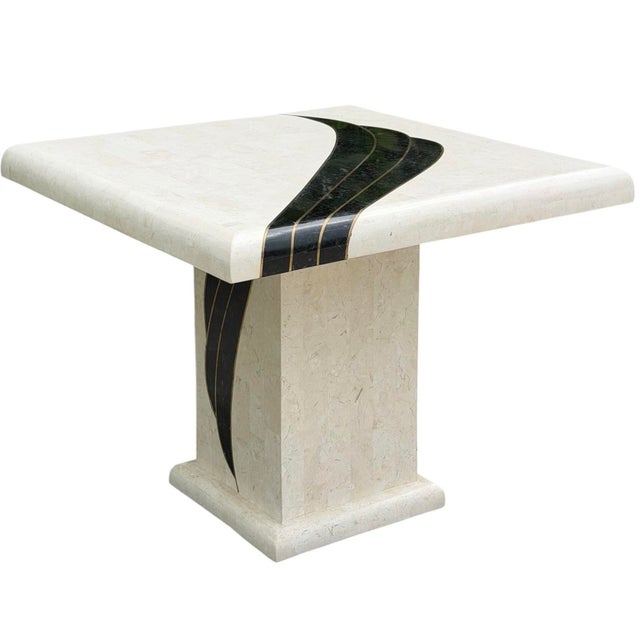Bold postmodern accent table dating to 1990, featuring a sculptural pedestal base and a dramatic flowing black inlay...