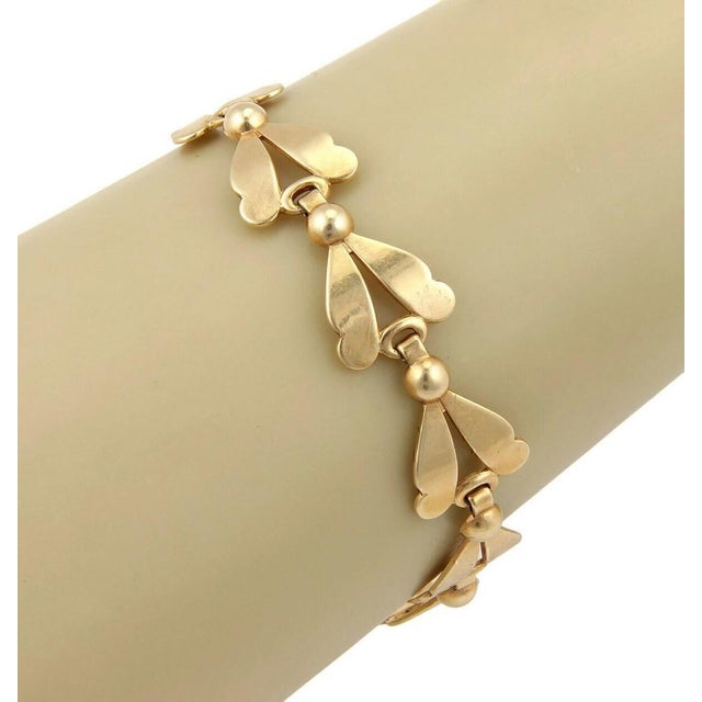 The Leaf & Bead 14k Yellow Gold Link Bracelet is a vintage piece of fine jewelry that exudes elegance and charm. The...