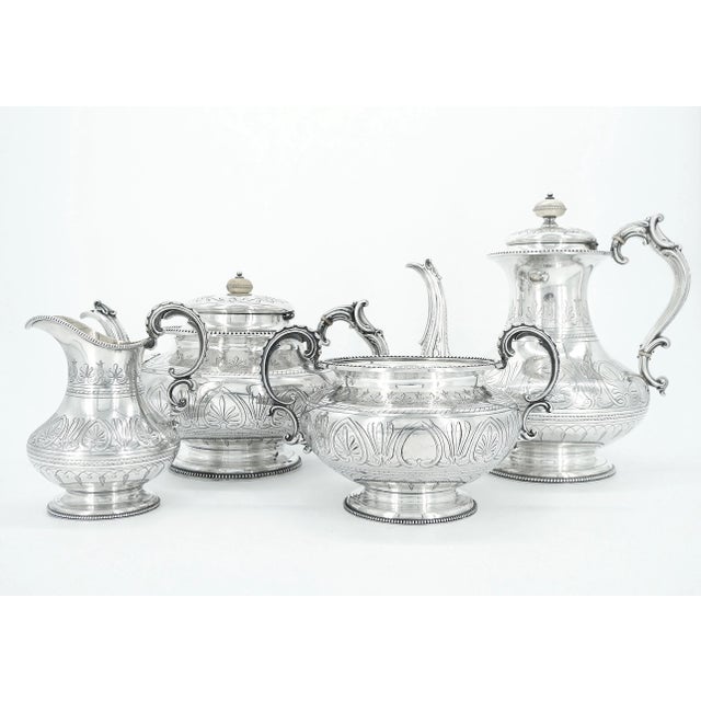Elevate your tea & coffee rituals to a level of timeless elegance with our exquisite English silver-plated four piece tea...