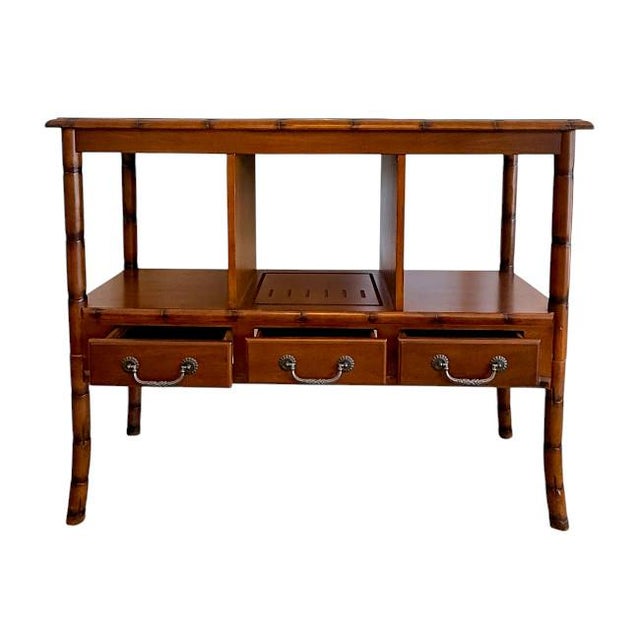 A beautifully crafted vintage faux bamboo console featuring warm honey-brown wood tones and elegant Asian-inspired...
