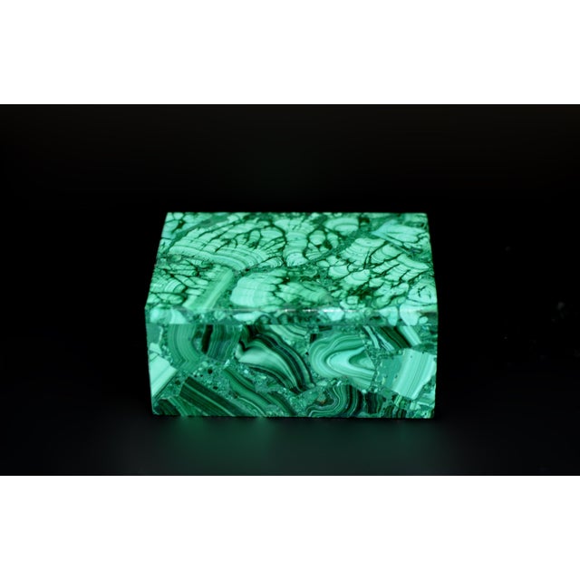 An exceptional decorative box crafted from natural malachite, showcasing the stone’s remarkable color and highly...