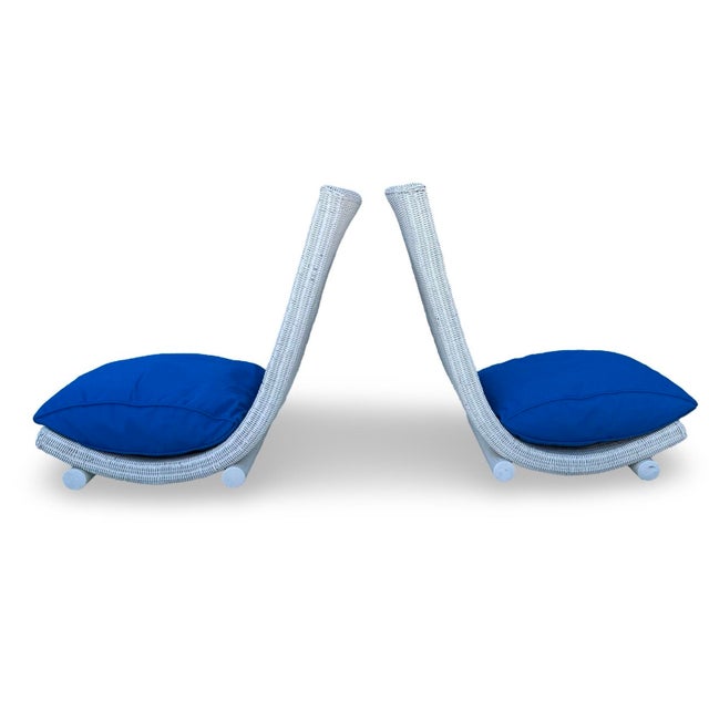 Showcasing a pair of 1960s wicker chairs, from the south of France, that exemplify classic mid-century design with their...