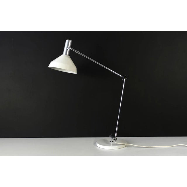 This Type 60 table lamp from Baltensweiler was produced in 1957 and can be adjusted into many positions. Up to 250V...