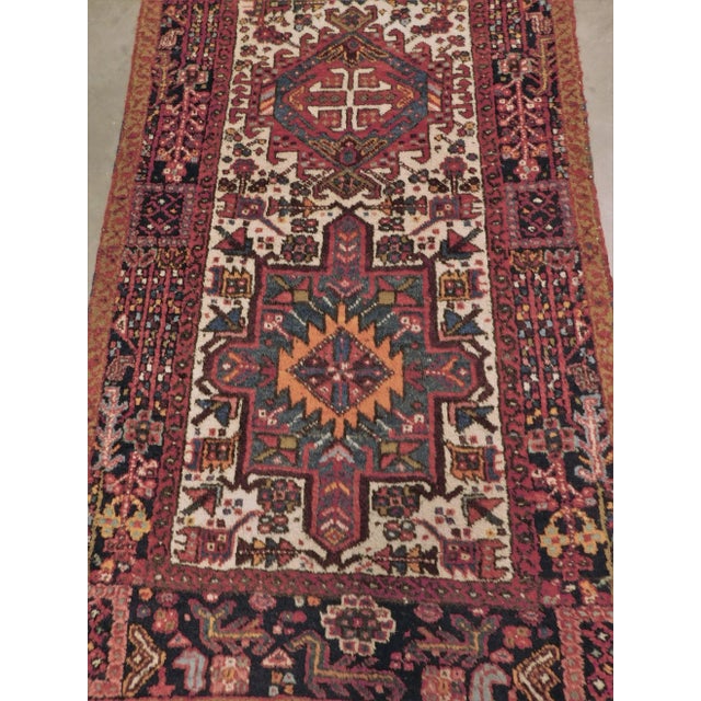 Five intricate geometric shapes on an ivory field. Wool pile on cotton foundation.