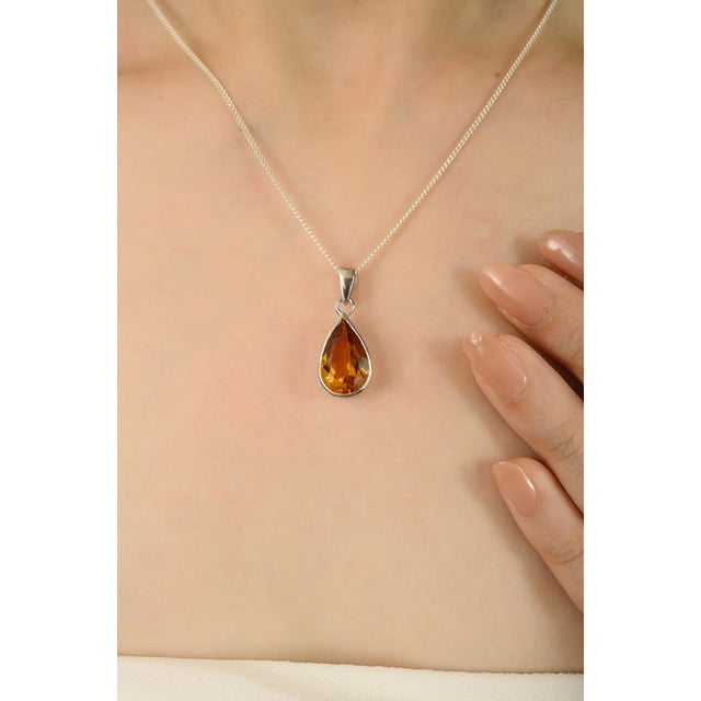 Timeless elegance and luminous beauty with this 925 Sterling Silver Natural Citrine faceted pear pendant. This teardrop...