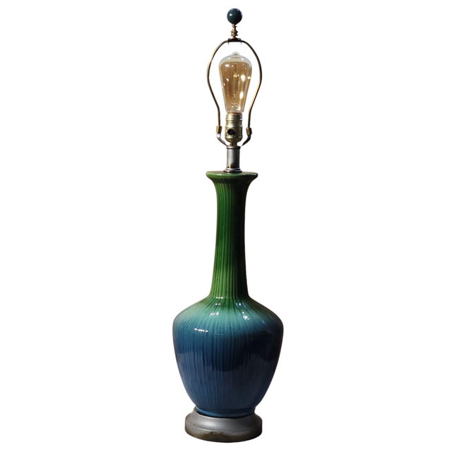 Striking mid century modern ceramic table lamp with graduated blue green glaze, in excellent working condition. Metal...