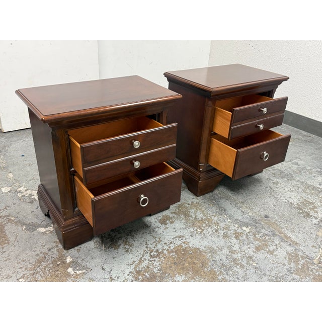 Design Plus Gallery presents a pair of Traditional Nightstands. This matching pair showcases a classic two drawer design...