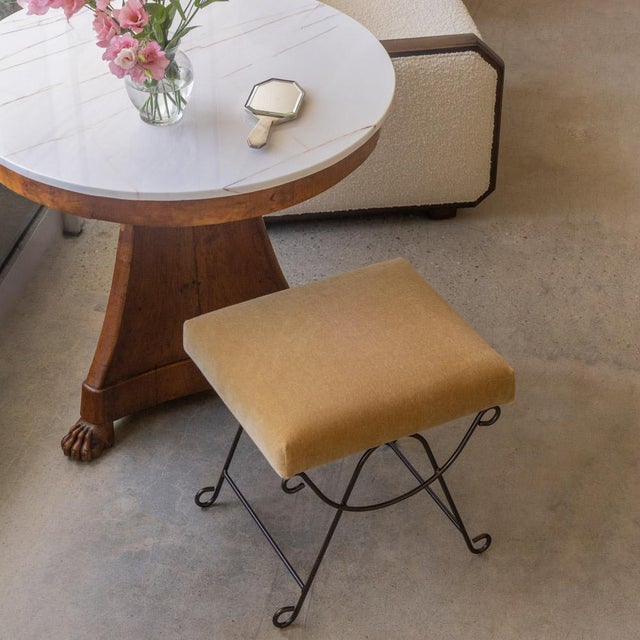 Beautiful iron stools with curved and looped base painted in a matte black finish. Rectangular cushioned seat upholstered...
