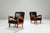 This striking pair of vintage lounge chairs showcase quiet strength and refined craftsmanship. Expertly constructed from...