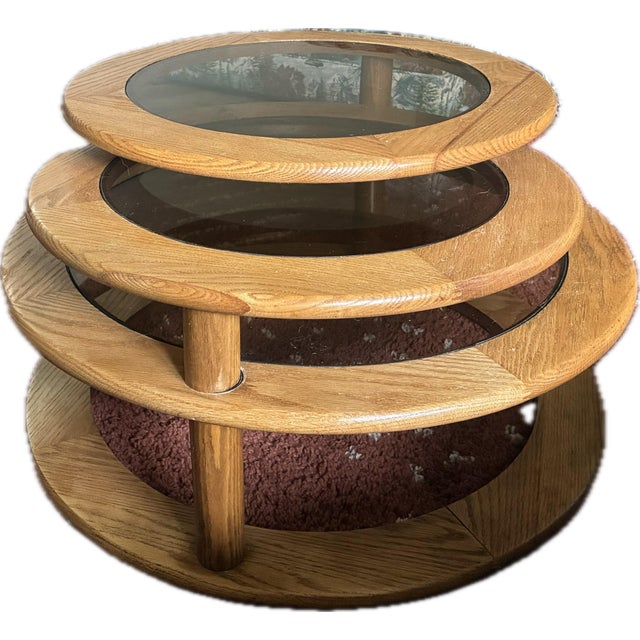 Mid Century Modern Three Tier Oak and Smoked Glass Swivel Coffee Table. Three-tiered coffee table in great condition...