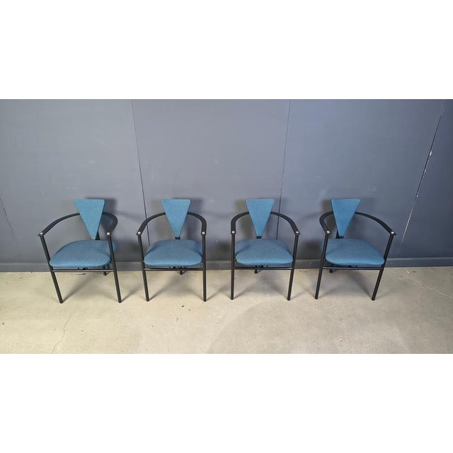 Set of four elegant dining room chairs manufactured by Belgochrom. Nicely designed black metal frames with elegant legs....