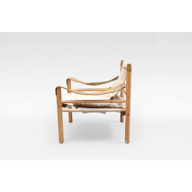 A legendary Sirocco Safari Lounge Chair by Arne Norell, crafted in Sweden in the 1960s and produced by Norell Möbel AB. A...